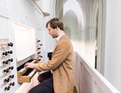 Universitätsorganist Daniel Beilschmidt spielt die Schwalbennestorgel im Paulinum der Universität Leipzig.